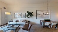 Located at 5445 Lankershim Blvd in Los Angeles, this thoughtfully designed single-floor residence offers a seamless blend of modern aesthetics and functional living. The open-concept living area is anchored by warm hardwood-style flooring, neutral toned walls, and generous natural light streaming through large sliding glass doors that lead to a private outdoor patio. The living space comfortably accommodates multiple seating arrangements and features a wall-mounted television alongside a media console, creating an inviting atmosphere for relaxation and entertainment.

The kitchen is outfitted with rich wood cabinetry, stainless steel appliances including a gas range and built-in refrigerator, a central island with dark countertops, and recessed lighting overhead — delivering both style and practicality. A dedicated kitchenette area with a double basin sink and built-in microwave provides additional utility.

The bedrooms are bright and serene, benefiting from large windows with sheer draping that diffuses natural light softly throughout. Each room offers generous wall space and hardwood-style flooring, with access to a walk-in closet. The bathroom is finished with warm wood vanity cabinetry, a large mirror, tile flooring, and a combined tub and shower enclosure with sleek glass sliding doors, completing this well-rounded residence.