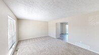 Located at 65 Carriage Station Dr in Cincinnati, OH, this two-story home offers a well-organized layout spread across two floors. The main level includes a welcoming entrance, a carpeted living room with a textured ceiling that opens into the dining area, and a galley-style kitchen featuring light granite countertops, taupe cabinetry, wood-look flooring, black appliances, and a window that brings in natural light. The lower level also includes a utility room for added convenience.

Upstairs, three carpeted bedrooms provide comfortable living spaces, each with textured ceilings and ample closet storage — the home features six closets in total. The primary bedroom is a generously sized retreat, while the additional bedrooms offer natural light through windows. A hallway connects the upper-level rooms, with staircase access from both floors.

The two bathrooms are finished with granite-topped vanities, wood-look tile flooring, and modern fixtures. One bathroom includes a built-in closet for additional storage, while the other showcases stylish gold-toned lighting above a framed mirror. Throughout the home, neutral tones and clean finishes create a bright, move-in ready atmosphere well-suited for everyday living.