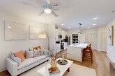 Located at 352 S Foster Dr in Baton Rouge, Louisiana, this well-designed one-bedroom, one-bathroom residence offers a thoughtful open-concept floor plan that maximizes every square foot. The living room is bright and welcoming, featuring a ceiling fan, large windows dressed with sheer curtains and blinds that invite abundant natural light, and warm wood-look flooring that flows seamlessly throughout the unit.

The kitchen is a true centerpiece, showcasing white shaker cabinetry with matte black hardware, a striking elongated pendant light, a generous white quartz waterfall island with an undermount sink and bar seating, and a full suite of stainless steel appliances. A dedicated walk-in pantry with built-in shelving provides exceptional storage, a rare and practical feature.

The bedroom is a comfortable retreat, fitted with a ceiling fan, a wide window offering leafy outdoor views, and a calm neutral palette. The bathroom is well-appointed with a white vanity, quartz countertop, a tiled shower-tub combo, and wood-look flooring that complements the rest of the home.

Crisp white walls, recessed lighting, and consistent warm-toned flooring create a cohesive, modern ambiance throughout this efficiently designed Baton Rouge residence.