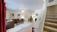 Located at 228 Dixie Dr in Tallahassee, FL, this two-story, 5-bedroom, 5-bathroom home offers a functional and comfortable layout across two evenly sized floors. The main level opens into a bright living room featuring light tile flooring, a ceiling fan, and a connected dining area, creating an open and social atmosphere. Warm-toned walls and tasteful décor give the space an inviting character. The galley-style kitchen is outfitted with white cabinetry, ample counter space, and full appliances including a refrigerator, stove, and dishwasher — all finished in a clean, all-white palette. The upper floor hosts additional bedrooms, including the primary bedroom, which features carpeted flooring and comfortable proportions. Each of the five bathrooms is finished with tile flooring and includes a tub-shower combination, providing practical amenity throughout. Bedrooms across both floors offer carpeted comfort and good natural light. A dedicated in-unit laundry area houses a full-size washer and dryer, adding everyday convenience. With three closets and a hallway connecting the upper level, this home is designed to accommodate multi-occupant living efficiently — making it well-suited for shared housing or larger households in the Tallahassee area.