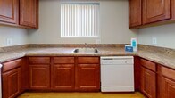 Located at 736 Camberwell Circle in Towson, MD 21204, this single-floor residence offers a practical and well-organized layout across a generous footprint. The living areas are finished with wall-to-wall carpet in a neutral tone, creating a warm and comfortable atmosphere throughout. Large windows fitted with vertical blinds allow ample natural light to flow into the main living spaces, providing a bright and open feel.

The kitchen features rich, warm-toned wood cabinetry, granite-style laminate countertops, a stainless steel sink, and a dishwasher. The hardwood-style flooring in the kitchen and utility areas adds a clean contrast to the carpeted rooms. A dedicated laundry area with a stacked washer and dryer is conveniently accessible from the main living space.

The bedrooms are generously sized, each with plush carpeting, neutral walls, and wide windows that invite natural light. One bedroom offers direct access to a private bathroom, while an additional full bathroom serves the rest of the unit. The primary bathroom includes a walk-in shower with a glass sliding door and white tile surround, while the secondary bathroom offers a full soaking tub and hardwood-style flooring. The overall design is clean, functional, and move-in ready.