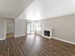 Unit 39 at The Valencia, located at 1101 N Camino Alto in Vallejo, California, is a single-floor residence thoughtfully designed for comfortable everyday living. The open living area makes an immediate impression with its dark hardwood-style flooring, neutral gray walls, and a classic white brick fireplace that serves as a focal point. A ceiling fan provides year-round comfort, and large windows fitted with blinds allow natural light to fill the space while offering outdoor views of the surrounding greenery.

The kitchen is efficiently laid out with warm wood cabinetry extending to the ceiling, dark countertops, tile flooring, and a full suite of stainless steel appliances including a refrigerator, dishwasher, and range. A window above the sink brings in additional natural light.

The bedrooms are carpeted for warmth and comfort, each featuring windows with blinds that invite natural light. One bedroom includes a sliding closet and direct access to a vanity area with warm wood cabinetry, a large mirror, and a well-lit fixture — a practical en-suite-style layout.

The bathroom is clean and functional, complete with a full soaking tub and shower combination. Throughout the unit, a consistent neutral color palette and textured ceilings create a cohesive, understated aesthetic.