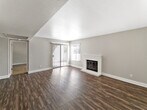 Unit 39 at The Valencia, located at 1101 N Camino Alto in Vallejo, California, is a single-floor residence thoughtfully designed for comfortable everyday living. The open living area makes an immediate impression with its dark hardwood-style flooring, neutral gray walls, and a classic white brick fireplace that serves as a focal point. A ceiling fan provides year-round comfort, and large windows fitted with blinds allow natural light to fill the space while offering outdoor views of the surrounding greenery.

The kitchen is efficiently laid out with warm wood cabinetry extending to the ceiling, dark countertops, tile flooring, and a full suite of stainless steel appliances including a refrigerator, dishwasher, and range. A window above the sink brings in additional natural light.

The bedrooms are carpeted for warmth and comfort, each featuring windows with blinds that invite natural light. One bedroom includes a sliding closet and direct access to a vanity area with warm wood cabinetry, a large mirror, and a well-lit fixture — a practical en-suite-style layout.

The bathroom is clean and functional, complete with a full soaking tub and shower combination. Throughout the unit, a consistent neutral color palette and textured ceilings create a cohesive, understated aesthetic.