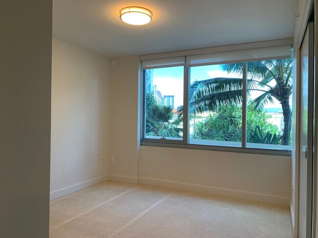 Bedroom with a tree top view - 1189 Waimanu St