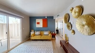 Located at 3985 N Stone Ave in Tucson, AZ, this thoughtfully designed one-bedroom, two-bathroom residence offers a smart and functional layout across a single floor. Light wood-style flooring runs throughout, lending a clean, cohesive look to every room.

The living room serves as the heart of the home, featuring a bold teal accent wall, sliding glass doors that open to a private outdoor patio, and abundant natural light. The kitchen is well-appointed with white shaker cabinetry, a classic subway tile backsplash, stainless steel appliances, and a practical layout that maximizes the available space.

The primary bedroom is a comfortable retreat with a sliding closet, a natural light-filled window, and a warm, inviting ambiance. A dedicated office space with its own closet and window provides a quiet area ideal for working or studying. The two bathrooms are clean and functional — one features a full tub/shower combination with matte black fixtures, wood-look flooring, and a single-sink vanity, while the other offers a shower with a stylish ring towel holder and neutral finishes.

A connecting hallway ties all rooms together efficiently, making this residence feel organized and complete despite its compact footprint.