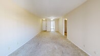 Located at 11614 Old Ballas Rd in Creve Coeur, Missouri, this three-bedroom, one-bathroom residence offers a practical and comfortable single-floor layout. The living area is generously sized, featuring soft wall-to-wall carpeting, a ceiling fan with light fixture, and a sliding glass door that opens to a private balcony with outdoor views — filling the space with natural light. The neutral, warm-toned walls throughout create a bright and cohesive atmosphere.

The spacious primary bedroom is notably large, providing ample room for furnishings, while the two additional bedrooms are well-proportioned with carpeted floors and windows that invite natural light. The layout includes two closets for convenient storage.

The kitchen is equipped with black appliances, including a refrigerator and dishwasher, complemented by wood-toned countertops, white cabinetry, and light flooring. A tall window with blinds brightens the kitchen and offers a view of the surrounding greenery.

The bathroom features tile flooring, a tub-shower combination with tiled surround, and a vanity with sink. A hallway connects the rooms efficiently, contributing to the home's overall functional flow. This residence offers a clean, move-in ready environment in a convenient Creve Coeur location.