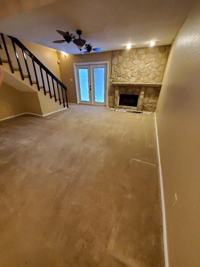 Large living room with fireplace and light from the balcony - 4107 Medical Dr
