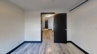 Located at 260 Sherbourne Street in Toronto's vibrant St. James Town neighbourhood, this one-bedroom, one-bathroom unit offers a compact yet efficiently laid-out single-floor living space. The interior is defined by a cohesive modern aesthetic, featuring light wood laminate flooring and bold black door frames and baseboards that create a sharp contrast against crisp white walls throughout.

The entry hallway leads into the main living areas, offering a functional flow between rooms. A standout architectural feature is the exposed red brick accent wall, which adds industrial character and warmth to the space. A barn-style sliding door rail is also visible, contributing to the unit's contemporary, urban design sensibility.

The bedroom is a well-proportioned private retreat, benefiting from a window fitted with a roller blind. The bathroom is cleanly finished with light grey tile flooring, a white vanity with under-cabinet storage, a toilet, and a window that allows for natural ventilation.

Throughout the unit, the white walls and light flooring create a bright, open feel that maximizes the sense of space. The consistent use of black trim detailing ties all areas together into a cohesive and stylish interior. This unit is well-suited for individuals seeking a practical urban home in a central Toronto location.