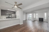 Located at 9211 Harlow Ave in Los Angeles, CA, this 2-bedroom, 2-bathroom single-floor home offers a well-designed layout with a clean, modern aesthetic. The open living area is a standout, featuring rich hardwood-style flooring, a classic fireplace flanked by tall windows that flood the space with natural light, and sliding glass doors that open to a private outdoor area. A ceiling fan adds comfort to the bright, airy atmosphere.

The kitchen connects seamlessly to the living and dining area via a pass-through counter, making it ideal for entertaining. It features dark wood cabinetry, a subway tile backsplash, stainless steel appliances including a refrigerator and microwave, and a clean white countertop that ties the space together.

Both bedrooms are carpeted and finished in neutral tones, offering a calm and restful environment. Each room receives natural light through well-placed windows. The primary bedroom is generously sized with its own dedicated closet. Two full bathrooms, each equipped with a tub-shower combination and wood-style flooring, provide functional convenience throughout the home. Additional closet storage is available to support everyday organization.