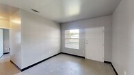 Located at 580 Oakhaven Cir in Immokalee, FL, this single-story residence offers a practical and well-organized layout across three bedrooms, one bathroom, and a dedicated kitchen. The interior is finished with light-toned tile flooring throughout and neutral-painted walls, giving the space a clean and consistent aesthetic.

The kitchen is equipped with white cabinetry, granite-look countertops, a stainless steel double-basin sink, a white electric range with overhead ventilation, and a full-size refrigerator. Ample upper and lower cabinet storage makes it a functional workspace.

Each of the three bedrooms features tile flooring, neutral walls, and windows with blinds that allow for natural light and outdoor views. The primary bedroom includes a built-in closet with a hanging rod, offering convenient storage. The additional bedrooms also include closets, with one featuring a window-facing orientation that enhances brightness. Some bedrooms display painted concrete block wall construction, contributing to the home's durable structural character.

The bathroom is outfitted with a full-size soaking tub and shower combination with a chrome fixture and curtain rod, accompanied by white cabinetry for storage. Overall, the space presents a straightforward, low-maintenance interior suited for comfortable everyday living.