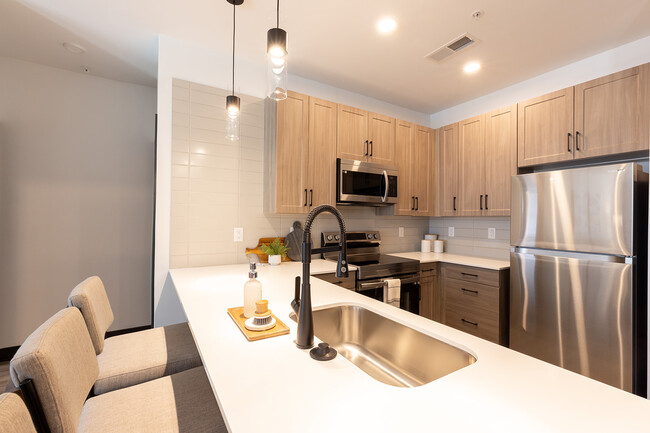 Kitchen with White Quartz Countertops - North End Apartments