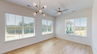 Located at 2800 Milan Court in Birmingham, Alabama, this well-appointed single-floor home offers four bedrooms and three bathrooms across a generously sized layout. The interior features a clean, contemporary aesthetic with light hardwood-style flooring throughout the main living areas and soft carpeting in the bedrooms. Crisp white walls and abundant natural light from large, blinds-fitted windows create a bright and airy atmosphere throughout.

The modern kitchen is a standout feature, showcasing light wood cabinetry that reaches the ceiling, white quartz countertops, a white subway tile backsplash, and a full suite of stainless steel appliances including a range with overhead hood, refrigerator, and dishwasher. The bedrooms are comfortably sized, with the primary suite offering an exceptionally spacious retreat complete with a large walk-in closet outfitted with built-in shelving and dual hanging rods. The three bathrooms are finished with white subway tile tub-and-shower surrounds, hardwood-style flooring, and brushed nickel fixtures.

A private balcony extends the living space outdoors, offering open views of the surrounding greenery and neighborhood streetscape. Additional conveniences include a dedicated laundry area with an in-unit washer, multiple closets for storage, and two hallways connecting the well-organized floorplan.