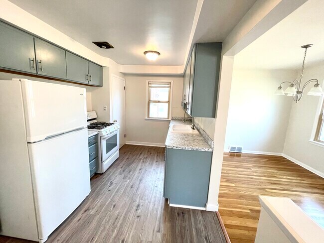 Plentiful cabinet space in freshly refinished grey cabinets with new satin pulls in all doors and drawers. - 4984 S Sedgewick Rd