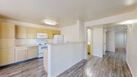 Located at 4445 Fountain Springs Grove in Colorado Springs, CO, this three-bedroom, two-bathroom single-floor home offers a practical and comfortable layout designed for everyday living. The open-concept kitchen and living area serves as the heart of the home, featuring light wood cabinetry, white appliances including a range, over-the-range microwave, and refrigerator, as well as a peninsula counter that provides additional workspace and separates the kitchen from the living area. Wood-look plank flooring runs throughout the main living spaces, lending a clean and cohesive look. The three bedrooms are carpeted for comfort and each features neutral walls and windows that bring in natural light, offering views of the surrounding neighborhood. The primary bedroom provides a generous footprint and includes access to a well-sized closet with wire shelving for organized storage. A second closet elsewhere in the home adds further storage convenience. The two bathrooms are finished in a clean, classic style, with one featuring a full tub-shower combo with tiled surround and chrome fixtures. A hallway connects the bedroom wing to the main living areas, creating a logical and private flow throughout the home. The overall aesthetic is bright, neutral, and move-in ready.
