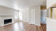 Located at 4035 Towne Crossing Blvd in Mesquite, TX, this single-floor, one-bedroom, one-bathroom residence offers a well-organized and functional layout. The living room is a bright, open space highlighted by wood-look hardwood flooring, a classic white-mantled fireplace, and multiple windows fitted with blinds that allow natural light to fill the room. A textured ceiling runs throughout the home, adding a consistent design element to each space. The kitchen connects to the living area via a pass-through counter, providing an efficient and open feel. The bedroom is a comfortable, carpeted retreat featuring a window with natural light, a closet with overhead storage, and direct access to the bathroom. The full bathroom is clean and straightforward, equipped with a tiled tub-shower combination and chrome fixtures. A dedicated laundry area adds practical convenience to the home. Neutral tones throughout the walls and flooring create a cohesive, move-in-ready aesthetic. The overall layout is compact yet thoughtfully designed, making efficient use of every area within the single-floor floor plan.