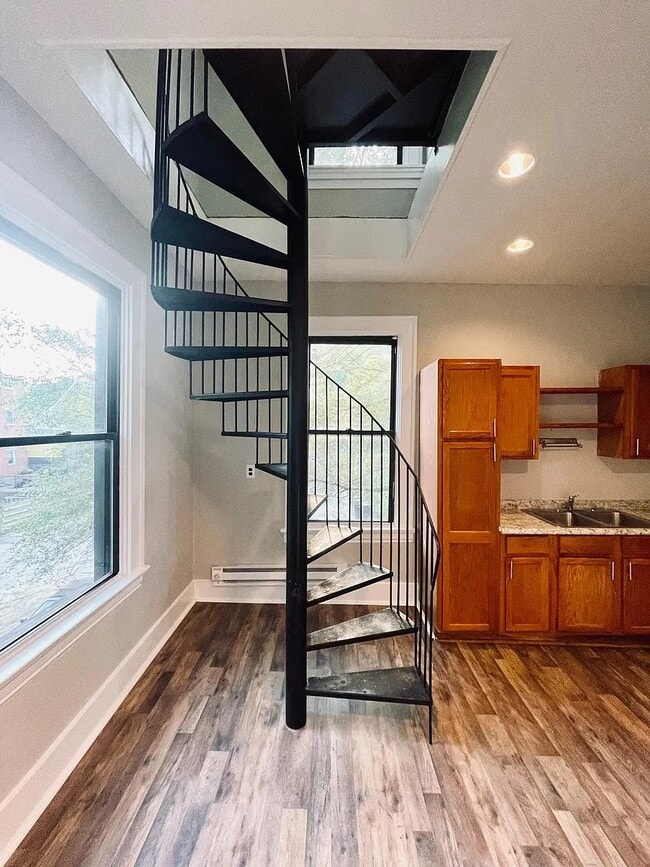 Spiral staircase and one of two means to access the living floor - 1813 Highland Ave