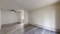 Located at 4425 Bidwell Dr in Fremont, CA, this one-bedroom, one-bathroom unit offers a well-organized, single-floor layout designed for efficient everyday living. Throughout the space, gray wood-look plank flooring provides a clean, contemporary foundation that ties each room together cohesively.

The combined living and dining area is the heart of the unit, featuring a textured ceiling, a ceiling fan with integrated light, and a sliding glass door that opens to a private patio, filling the room with natural light and offering a seamless indoor-outdoor connection. A baseboard heating system runs along the walls, ensuring year-round comfort.

The galley-style kitchen is outfitted with gray shaker cabinetry accented by matte black hardware, white countertops, and a full suite of stainless steel appliances including a refrigerator, electric range, over-the-range microwave, and dishwasher.

The bedroom is a comfortably sized retreat featuring a large window that brings in natural light and outdoor views, along with a baseboard heater and two closets for ample storage.

The bathroom includes a full tub-shower combination with clean white surrounds, complemented by matching flooring and neutral wall tones. The unit's light, neutral color palette and updated finishes create a bright and functional living environment.