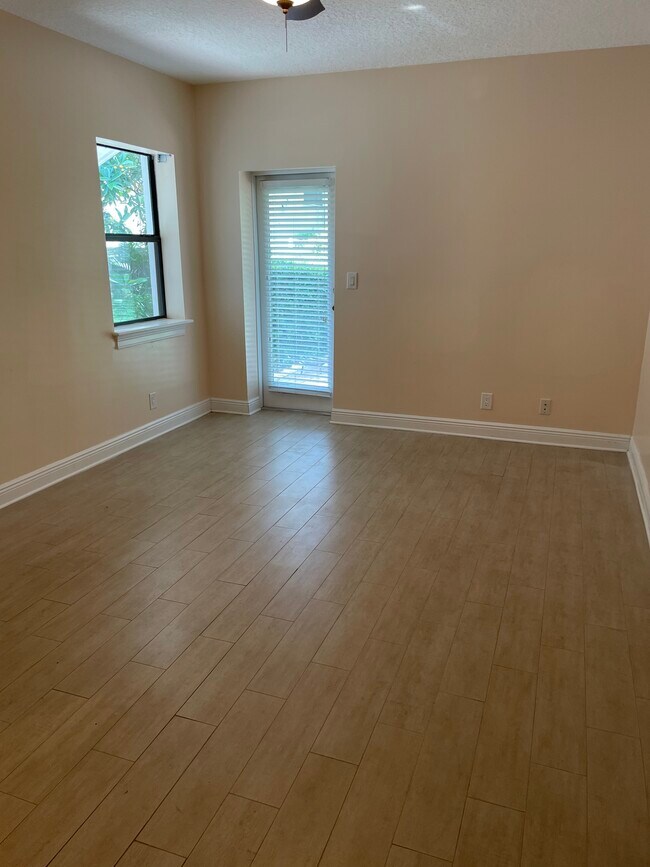 Master bedroom with outside door and view of the lake. - 3005 W Sligh Ave