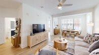 Located at 200 Brooklawn St in Farragut, TN, this well-appointed 2-bedroom, 2-bathroom single-floor residence offers a thoughtfully designed open-concept layout. Light hardwood flooring flows throughout, complemented by crisp white walls and ceiling fans in the main living areas.

The kitchen is a standout feature, showcasing a striking two-tone design with bold navy lower cabinets, white upper cabinets, and a decorative tile backsplash. A large central island with a white quartz countertop and bar seating serves as both a prep space and gathering spot. Stainless steel appliances, including a french door refrigerator, range, microwave, and dishwasher, complete the space. Pendant lighting adds a polished finish. The kitchen flows seamlessly into the dining and living areas, which are brightened by large windows offering natural light.

The generously sized primary bedroom includes a walk-in closet with wire shelving. The bathrooms feature dark cabinetry with dual sinks, white quartz countertops, and a subway-tiled tub-shower combination. A dedicated laundry room houses a full-size side-by-side washer and dryer. The second bedroom is bright and airy with natural light and a ceiling fan, making this a comfortable and functional home.