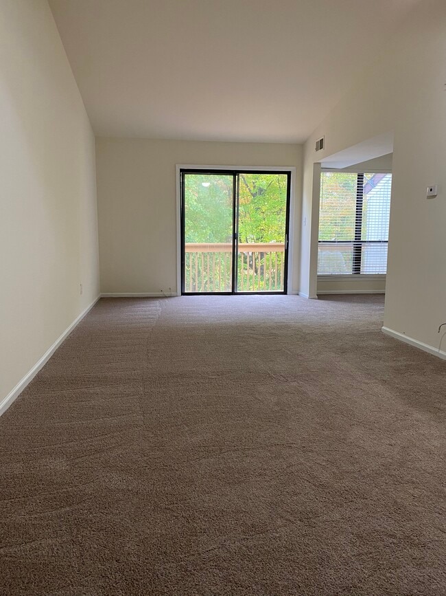 Living room area with access to dining room and outside deck. - 1825 Bridgetown Pike