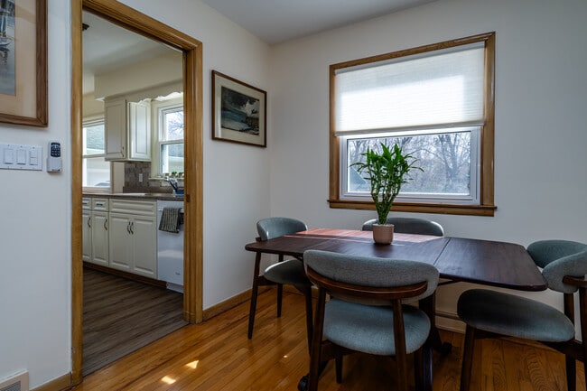 Enjoy meals in this charming dining area with hardwood floors, natural light, and seating for four. - 2767 Oakwood Ln