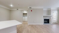 This contemporary 680 square foot apartment offers a thoughtful blend of comfort and style. The heart of the home is the open-concept kitchen and living area, showcasing a sleek, modern design. The kitchen boasts crisp white cabinetry, stainless steel appliances, and a functional island, perfect for meal preparation or casual dining.

The living room is anchored by an elegant fireplace, adding warmth and ambiance to the space. Large windows flood the area with natural light, while neutral-toned walls and light wood-look flooring create a bright, airy atmosphere throughout.

The spacious 160 square foot bedroom features plush carpeting and ample closet space. The bathroom is well-appointed with a modern vanity and a shower/tub combination. Additional highlights include in-unit laundry facilities and a small office nook, ideal for remote work or study.

Located in Aurora, CO, this apartment combines modern conveniences with a comfortable living environment, making it an ideal choice for those seeking a contemporary urban lifestyle.