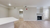 This contemporary 680 square foot apartment offers a thoughtful blend of comfort and style. The heart of the home is the open-concept kitchen and living area, showcasing a sleek, modern design. The kitchen boasts crisp white cabinetry, stainless steel appliances, and a functional island, perfect for meal preparation or casual dining.

The living room is anchored by an elegant fireplace, adding warmth and ambiance to the space. Large windows flood the area with natural light, while neutral-toned walls and light wood-look flooring create a bright, airy atmosphere throughout.

The spacious 160 square foot bedroom features plush carpeting and ample closet space. The bathroom is well-appointed with a modern vanity and a shower/tub combination. Additional highlights include in-unit laundry facilities and a small office nook, ideal for remote work or study.

Located in Aurora, CO, this apartment combines modern conveniences with a comfortable living environment, making it an ideal choice for those seeking a contemporary urban lifestyle.