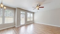 Located at 159 Ireland Ln in Dallas, GA, this two-story home offers four bedrooms, five bathrooms, and a well-designed layout spread across two floors. The main level features an open-concept living, dining, and kitchen area with warm hardwood-style flooring and a ceiling fan with light fixture. Natural light pours in through multiple windows fitted with blinds, creating a bright and welcoming atmosphere. The kitchen is a standout space, equipped with granite countertops, a central island, gray cabinetry, stainless steel appliances, and ample overhead storage — all complemented by a window above the sink that overlooks the exterior. A dedicated laundry room on the main level includes a washer and dryer with wire shelving above. The attached garage features a paneled double door with transom windows, providing additional storage or parking. Upstairs, the four bedrooms are finished with plush carpeting and neutral tones, offering a calm and comfortable retreat. The generously sized primary bedroom includes its own bathroom and a walk-in closet with wire shelving. Five bathrooms in total are distributed throughout the home, ensuring convenience for residents and guests. With six closets and multiple hallways, storage and circulation are thoughtfully addressed throughout this well-appointed Dallas home.