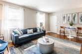 Located at 1762 Walker Ave in Union, NJ, this single-floor residence offers a thoughtfully designed layout with a warm and inviting atmosphere throughout. The living room serves as a central gathering space, featuring rich hardwood floors, neutral toned walls, and multiple windows dressed with sheer white curtains that allow generous natural light to fill the room. The space comfortably accommodates a full seating arrangement, making it ideal for both relaxing and entertaining.

The kitchen is efficiently laid out with light wood cabinetry, granite-style countertops, and tile flooring. A gas range, stainless steel microwave, and full-size refrigerator provide all essential appliances, while a built-in counter with bar seating offers a convenient casual dining option. A window above the counter brings in natural light and outdoor views of surrounding greenery.

The bedrooms are calm and well-proportioned, each featuring hardwood floors and windows that invite natural light. One room is well-suited as a home office or flex space, with chair-rail molding, hardwood floors, and windows on two walls creating a bright, functional environment.

The bathroom is finished with clean white tile work, a full soaking tub with a mosaic accent tile border, and a classic, understated design. Overall, the home presents a cohesive, move-in-ready aesthetic with a comfortable and practical layout.