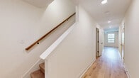Located at 940 Britton Springs Road in Clarksville, Tennessee, this two-story home offers three bedrooms and three bathrooms across two well-organized floors. The main level houses an open-concept kitchen and living area finished with light wood-look flooring and recessed lighting. The kitchen is equipped with gray shaker-style cabinetry, granite-look countertops, a stainless steel appliance suite including a French door refrigerator, dishwasher, and range, and a clean white subway tile backsplash. A convenient half bath is also located on this floor. Upstairs, the layout expands to accommodate all three bedrooms, connected by a hallway featuring light wood flooring and a carpeted staircase with a warm wood handrail. The generously sized primary bedroom features plush carpet, a ceiling fan with light fixture, and a large multi-pane window that brings in natural light and neighborhood views. The additional bedrooms also include ceiling fans and a mix of carpet and wood-style flooring. The bathrooms are finished in a clean, neutral palette with gray vanities and a tub-shower combo. Two closets provide practical storage. The home's crisp white walls and consistent finishes give it a fresh, move-in-ready feel throughout.
