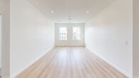 Located at 710-712 Main St in Middletown, CT, this 3-bedroom, 1-bathroom unit offers a clean, modern aesthetic throughout its well-organized single-floor layout. The open living area is bright and airy, featuring light-toned hardwood floors, recessed lighting, and double windows that invite natural light and street views of downtown Middletown. The kitchen is thoughtfully designed with white shaker cabinetry, granite countertops, a classic subway tile backsplash, and a full suite of stainless steel appliances including a refrigerator, range, microwave, and dishwasher. An in-unit washer is also conveniently included. The three bedrooms are carpeted in a soft, neutral tone and each features bright white walls, recessed lighting, and windows with views of the surrounding neighborhood. The primary bedroom includes a dedicated closet. The bathroom is finished with large-format marble-style tile on both the floor and tub surround, creating a clean and polished look. A hallway connects the rooms efficiently, and a dedicated closet provides additional storage. The unit's fresh, neutral palette and modern finishes make it a move-in ready space in the heart of Middletown.