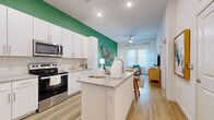 Located in the heart of Tampa at 510 North Rome Avenue, this well-designed one-bedroom, one-bathroom residence offers a thoughtful layout that maximizes every inch of its compact footprint. Light-toned hardwood-style flooring runs throughout, tying together each room with a warm, cohesive aesthetic.

The open-concept kitchen is a standout feature, boasting crisp white cabinetry that extends to the ceiling, granite countertops, stainless steel appliances, and a central island with bar seating — ideal for casual dining or entertaining. A bold green accent wall bridges the kitchen and living area, lending a vibrant, modern energy to the space.

The living room is bright and airy, with large windows dressed in sheer white curtains that allow natural light to fill the room. A ceiling fan adds comfort, while the open sightlines create a generous sense of space.

The bedroom is a serene retreat, featuring natural light from well-appointed windows, light wood flooring, and ample room to furnish comfortably. The bathroom continues the design language of the home with granite countertops, white cabinetry, and a tub-shower combination. A closet adjacent to the bathroom provides convenient storage. This residence delivers a polished, move-in-ready experience in a prime Tampa location.
