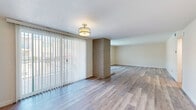Located at 9070 Florence Ave in Downey, CA, this 2-bedroom, 3-bathroom residence offers a thoughtfully designed single-floor layout with modern updates throughout. Light-toned luxury vinyl plank flooring runs seamlessly across the entire space, complementing the neutral wall tones and creating a bright, cohesive aesthetic.

The dual living areas are connected by a distinctive exposed brick column, adding a subtle architectural character. Large sliding glass doors with vertical blinds open to a private balcony, flooding the space with natural light and providing outdoor views. A separate dining room and entrance hallway complete the common areas.

The kitchen is well-appointed with gray shaker-style cabinetry, marble-look countertops, a subway tile backsplash, stainless steel appliances including a refrigerator and dishwasher, and a window above the sink for added brightness.

The generously sized primary bedroom features large windows with vertical blinds and benefits from a spacious walk-in closet outfitted with built-in shelving and hanging rods. Three closets in total offer ample storage throughout.

All three bathrooms are tastefully updated, featuring large-format tile surround, a decorative mosaic accent border, and clean white fixtures — one bathroom includes a soaking tub. The overall ambiance is clean, modern, and move-in ready.