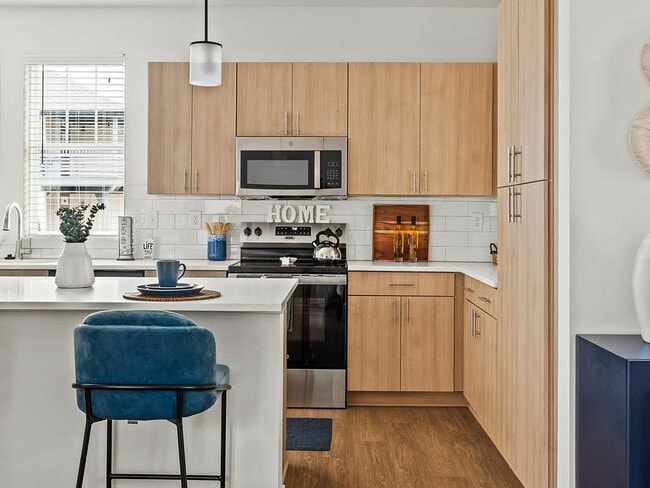 Kitchen with light cabinets & stainless steel appliances - LEO at Carmel - SINGLE FAMILY RENTAL HOMES