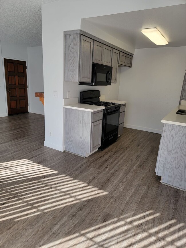 Living room and adjacent kitchen - 3751 S Canfield Ave