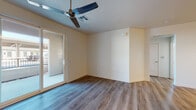 This single-floor residence at 915 W Lathrop Rd in Manteca, California, offers a thoughtfully designed open-concept layout with contemporary finishes throughout. The living area is bright and welcoming, featuring durable wood-look plank flooring, neutral-toned walls, and a ceiling fan that enhances airflow and comfort. A sliding glass door connects the living space to an outdoor area, bringing in natural light and a sense of openness.

The kitchen is well-appointed with dark cabinetry, stainless steel appliances including a refrigerator, range, and dishwasher, and light countertops that provide generous prep space. A peninsula with a built-in sink serves as both a functional workspace and a natural divider between the kitchen and living area. Recessed lighting illuminates the kitchen efficiently.

Additional rooms include a bedroom with a large window that frames outdoor views and fills the space with natural light, complemented by the same wood-look flooring found throughout. The bathroom features a tub-shower combination, a dark-cabinet vanity with a light countertop, and a small window for ventilation. A dedicated laundry area includes an in-unit front-loading Whirlpool washer with overhead dark cabinetry for added storage. The overall ambiance is clean, modern, and move-in ready.