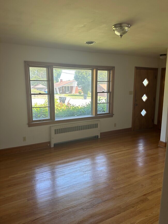 Light-filled living room with front door view - 455 Fleming Ave NE