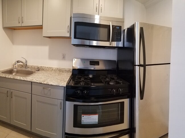 Brand new kitchen with stainless steel appliances include full size fridge, ventless microwave vent hood, gas operated stove, new back splash, and soft close hinges - 830 Spruce Ct
