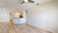 Located in San Diego's desirable 92130 zip code, this well-designed 2-bedroom, 2-bathroom single-story home offers a bright and functional layout with quality finishes throughout. The open-concept living and dining area features light wood-look flooring, crisp white walls, and ceiling fans, creating an airy and comfortable atmosphere. The kitchen is a standout, equipped with white shaker cabinetry, stainless steel appliances including a refrigerator and built-in microwave, a decorative tile backsplash, dark quartz countertops, and a peninsula island with pendant lighting — ideal for both cooking and casual dining. Both bedrooms are carpeted and generously sized, each with ceiling fans, natural light from windows with blinds, and access to ample closet storage — five closets are distributed throughout the home. The bathrooms are finished with neutral tile surrounds, soaking tub and shower combinations, modern vanities, and clean, contemporary fixtures. A dedicated laundry room houses a full-size washer and dryer. The attached garage provides secure parking and additional storage space with a concrete floor and automatic door opener. This home combines comfort, practicality, and modern style in a convenient San Diego location.