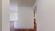 This 890 square foot apartment in Austin, TX offers a blend of modern comfort and practical design. The open-concept layout seamlessly integrates the living room, dining area, and kitchen, creating a spacious feel. The kitchen boasts wood cabinetry, granite countertops, and pendant lighting, with a curved breakfast bar that adds functionality and style.

Both bedrooms are generously sized, with the primary bedroom measuring 160 square feet. Each room features plush carpeting and ceiling fans for comfort. The bathrooms are well-appointed with granite countertops, large mirrors, and a combination of tile and beige-toned walls.

The living area is a highlight, with rich hardwood flooring and a cozy fireplace. Large windows throughout the apartment, including sliding glass doors, flood the space with natural light and offer scenic views. Modern lighting fixtures, including a striking drum pendant in the dining area, add contemporary flair.

Additional features include window blinds for privacy, in-unit laundry, and ample closet space. The apartment's neutral color palette provides a versatile backdrop for various decor styles. With its thoughtful design and desirable amenities, this apartment offers a comfortable and stylish living experience in the heart of Austin.