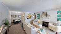 Located at 231 Calibre Chase Dr in Raleigh, NC, this single-floor residence offers a well-designed, open layout that connects the main living spaces with ease. The living room serves as the heart of the home, featuring a classic fireplace framed by a white mantel, teal-accented built-in shelving, and plush carpeting that extends throughout much of the space. A pass-through window connects the living area to the kitchen, enhancing the open feel while maintaining distinct zones.

The dining area is finished with wood-look flooring, crown molding, chair rail detailing, and a pendant light, creating a refined yet welcoming atmosphere. The kitchen is equipped with stainless steel appliances including a gas range and refrigerator, light stone countertops, white cabinetry, and direct access to an in-unit laundry area.

The primary bedroom is generously sized, offering a walk-in closet and private en-suite bathroom, while a second bedroom features sliding door access to a private outdoor space and large windows that bring in abundant natural light. The bathroom includes a full tub-shower combination with wood-look flooring. A bright bonus room with multiple windows and a ceiling fan offers flexible use as an office or additional living space.