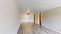 Located at 202 Safe Harbor Dr in Goodlettsville, TN, this two-bedroom, one-bathroom single-story home offers a practical and comfortable layout. The living room is a standout space, featuring built-in shelving and cabinetry along one wall, a ceiling fan with light fixture, crown molding, and durable wood-look flooring that extends throughout the main areas. Natural light filters in through a large front window, creating a bright and welcoming atmosphere. The kitchen is outfitted with white cabinetry, light countertops, a stainless steel sink, and black appliances including a range, dishwasher, and refrigerator. It connects conveniently to the living area, supporting an open flow. Both bedrooms are carpeted and feature crown molding and natural light from windows with blinds. The primary bedroom includes a closet with built-in shelving and a hanging rod for ample storage. The full bathroom is clean and functional, with a white vanity, tub-shower combination, and wood-look flooring. A dedicated laundry area houses the water heater and washer/dryer hookups. Two hallways connect the rooms efficiently throughout the single-floor layout.