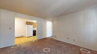 Located at 321 S Fifth St in Ames, Iowa, this 530-square-foot apartment offers a practical and efficient single-floor layout with 2 bedrooms and 1 bathroom. The carpeted living room provides an open, comfortable space that flows directly into the kitchen, which features warm oak cabinetry, granite-look countertops, tile flooring, and a full suite of appliances including a refrigerator, electric range, dishwasher, and range hood. A ceiling fan with light fixture adds air circulation to both the kitchen/dining area and the bedrooms. The primary bedroom measures a generous 190 square feet and includes a wall-mounted air conditioning unit, a baseboard heater, and large windows with vertical blinds that allow ample natural light. The second bedroom is bright and cozy, also featuring carpet, a baseboard heater, and a ceiling fan. A dedicated closet provides additional storage. The full bathroom is finished with tile flooring, an oak vanity, and a tub/shower combo. Baseboard heating is present throughout the unit, ensuring consistent warmth. The textured ceilings and clean white walls give the apartment a simple, functional aesthetic well-suited for comfortable everyday living.