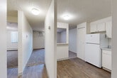 Located at 929 S Peoria St in Aurora, Colorado, this single-floor unit offers two bedrooms and three bathrooms within a practical and functional layout. The combined living and dining area provides a versatile open space, with carpeted flooring that adds warmth underfoot and windows fitted with vertical blinds that allow natural light to filter in. A wall-mounted HVAC unit and baseboard heating ensure year-round comfort.

The L-shaped kitchen is outfitted with white cabinetry offering ample storage, laminate countertops, a built-in sink, a white electric range, and a full-size refrigerator. Wood-look flooring runs throughout the kitchen and connecting hallways, creating a clean contrast with the carpeted living and bedroom areas.

Both bedrooms are carpeted and feature textured ceilings and sliding-door closets for storage. The primary bedroom is a comfortable size, while the second bedroom also includes closet access. Three closets are distributed throughout the unit, providing additional storage flexibility.

The three bathrooms are finished with white tile tub-and-shower combinations and wood-look flooring. One bathroom features a window above the tub, bringing in natural light. The hallways connect all areas of the unit efficiently, and textured ceilings are consistent throughout the space.