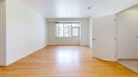 Located at 334 S Main St in the heart of Downtown Los Angeles, this 2-bedroom, 2-bathroom unit offers a well-designed single-level layout with a clean, contemporary aesthetic. The open living area features warm hardwood flooring that extends throughout the common spaces, creating a bright and cohesive feel. Large windows frame views of the surrounding Downtown LA skyline and historic architecture, filling the space with natural light.

The kitchen is efficiently designed with a peninsula counter featuring a dark stone countertop, warm wood cabinetry, stainless steel appliances including a refrigerator and range, and recessed lighting overhead. It flows directly into the living area, supporting an open, functional layout.

Both bedrooms are carpeted and offer a comfortable scale, with large windows providing urban views and ample natural light. The primary bedroom includes a dedicated closet with built-in shelving. The second bedroom also features a double-door closet for additional storage.

Both bathrooms share a consistent design language, featuring white subway-tiled tub-shower combinations, warm wood vanities with dark countertops, square vessel-style sinks, and light ceramic tile flooring. A dedicated closet provides further storage within the unit.