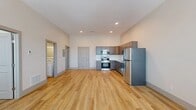 Located on the third floor at 870 Westminister Street in Providence, Rhode Island, this well-appointed one-bedroom, one-bathroom unit offers a clean, modern aesthetic throughout. The open-concept living and kitchen area creates a bright, airy atmosphere, anchored by warm light hardwood flooring that extends seamlessly through every room.

The kitchen is thoughtfully designed with gray shaker-style cabinetry, granite countertops, a white subway tile backsplash, and a full suite of stainless steel appliances including a range, over-the-range microwave, dishwasher, and refrigerator. The generous open layout provides ample space for both dining and lounging.

The bedroom is a comfortable, well-proportioned retreat featuring multiple windows that invite natural light and offer views of the surrounding area. A ceiling fan adds convenience, and a dedicated closet provides practical storage. The room connects conveniently to both the bathroom and the main living space.

The bathroom is clean and functional, featuring a glass-enclosed walk-in shower with chrome fixtures. Neutral wall tones and white cabinetry complete the refined look. Recessed lighting and consistent trim details throughout the unit reinforce a cohesive, contemporary design that suits a variety of lifestyles.