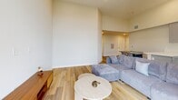Located at 748 Irolo St in Los Angeles, this thoughtfully designed single-floor unit offers three bedrooms and two bathrooms within a efficiently arranged floor plan. The space features consistent light wood-tone flooring and neutral white walls throughout, creating a cohesive, airy aesthetic enhanced by notably high ceilings that amplify the sense of openness.

The combined living and kitchen area serves as the heart of the unit. The kitchen is appointed with gray shaker-style cabinetry, white quartz countertops, a peninsula, stainless steel appliances including a gas range with wall-mounted hood, dishwasher, and refrigerator. The adjacent living area opens directly onto a private balcony through floor-to-ceiling sliding glass doors, offering urban views of the surrounding Koreatown neighborhood.

The bedrooms are accessed via a clean, well-lit hallway with sliding closet storage. Each bedroom features high ceilings and windows with city views. The primary bedroom is a comfortable size with direct hallway access.

Both bathrooms are finished with gray shaker vanities, backlit mirrors, white quartz countertops, and full tub-shower combinations, maintaining a consistent modern aesthetic throughout the unit.