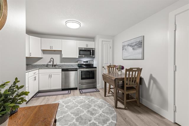 The kitchen features bright and beautiful white shaker cabinets, stainless steel appliances, a small - 605 White Cedar Blvd