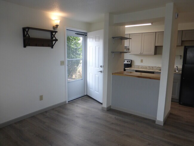 Entry into the home with open concept living room and kitchen. - 215 8th St SE