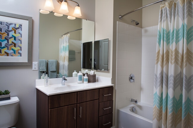 Classic Bath with chocolate pecan cabinetry, white laminate countertops, and hard surface flooring - Avalon Framingham